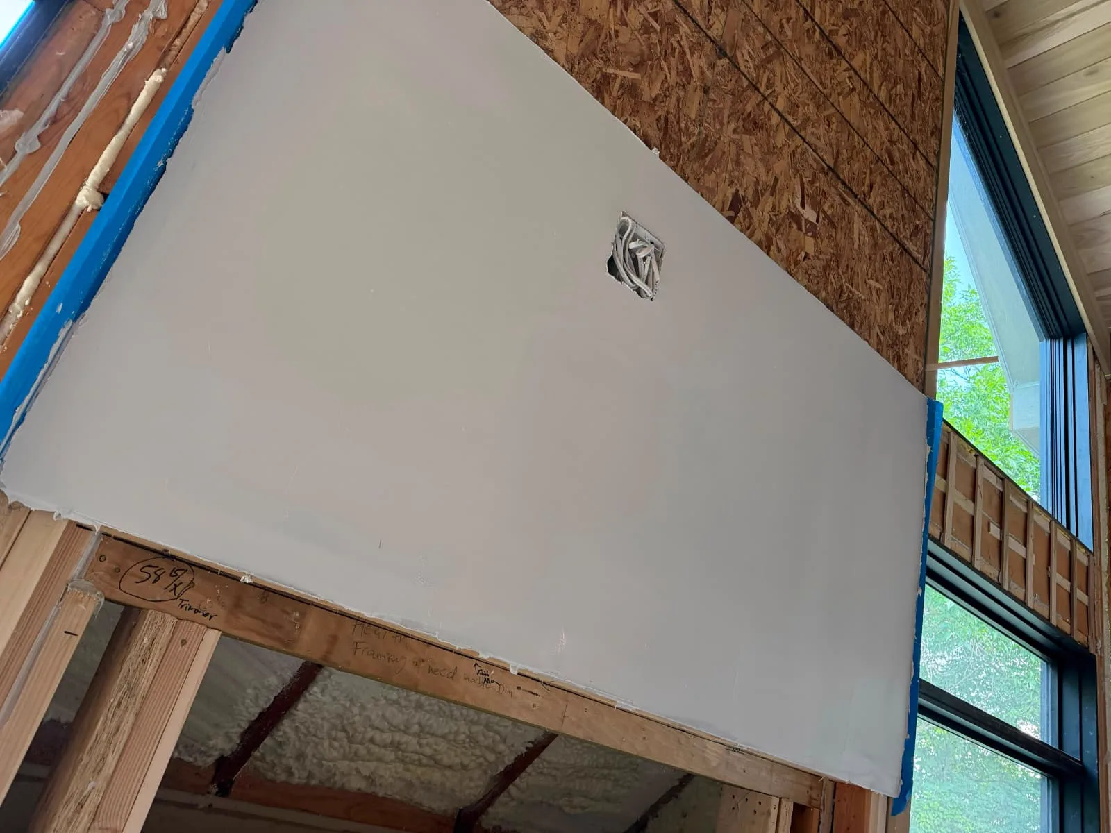Board going up over framing and foam