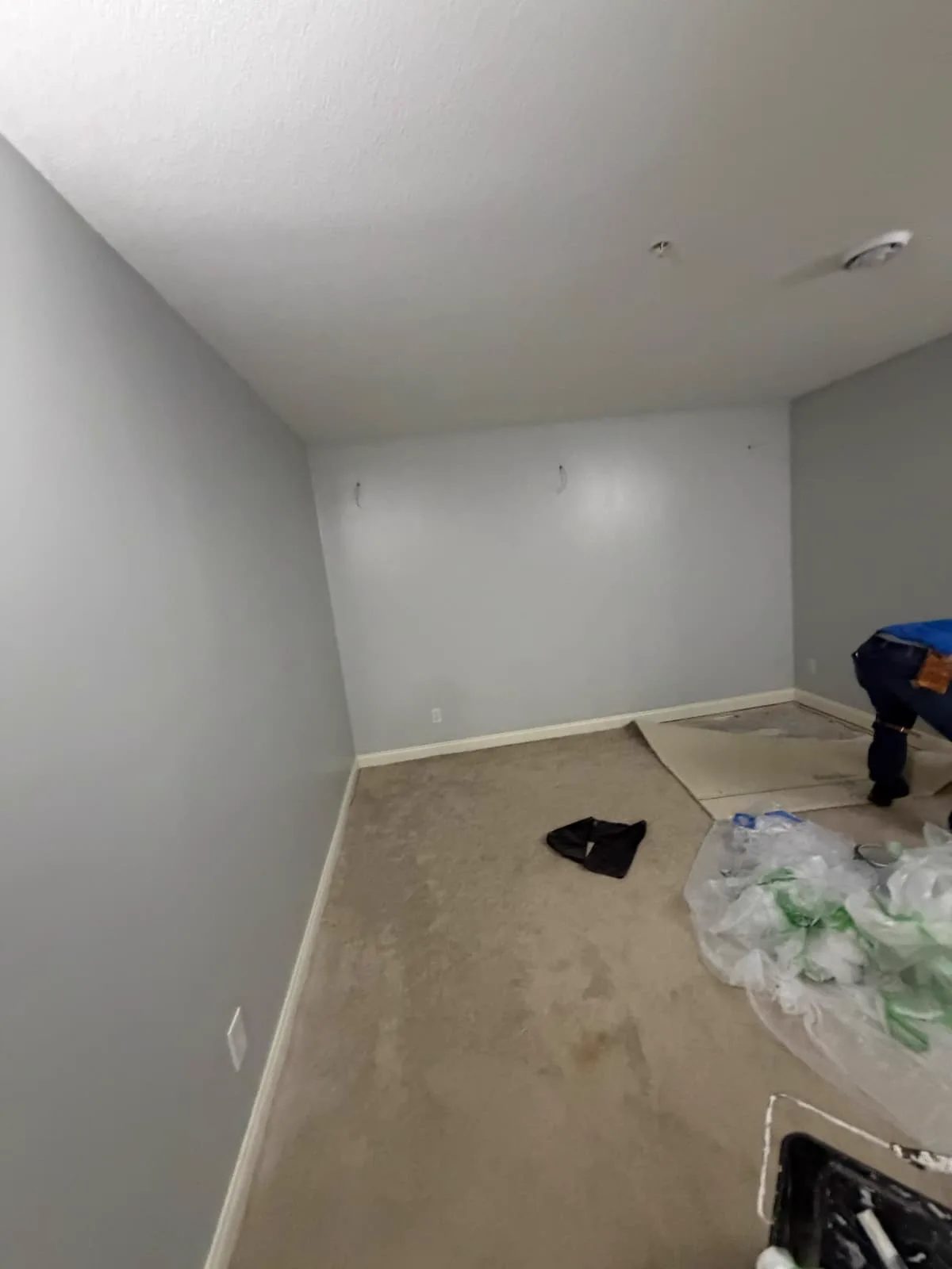 The same room mid-paint, masked and dropped